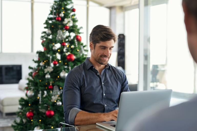 Hombre mirando y escribiendo en un computador